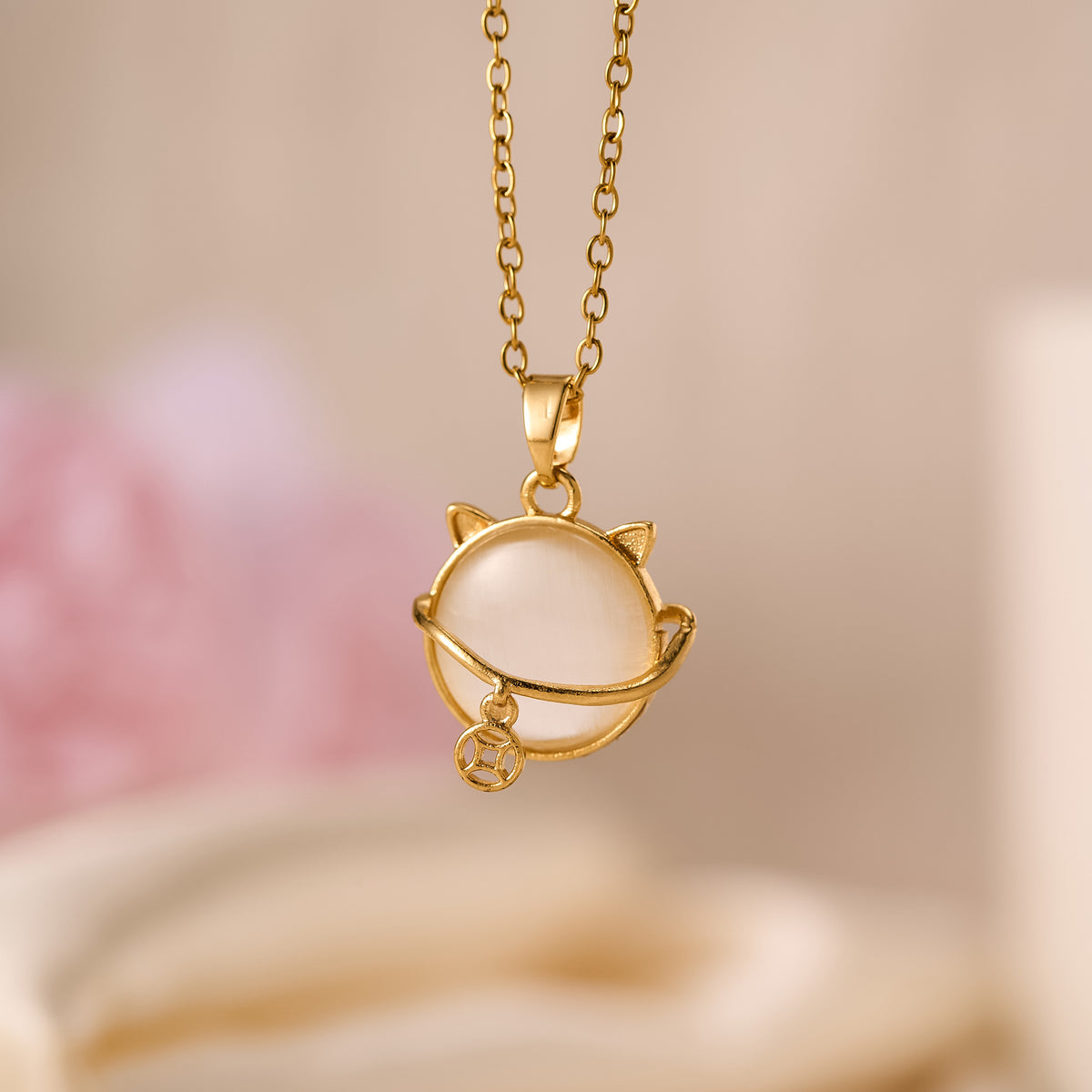 CAT Pendant featuring a white orb and a small lucky charm